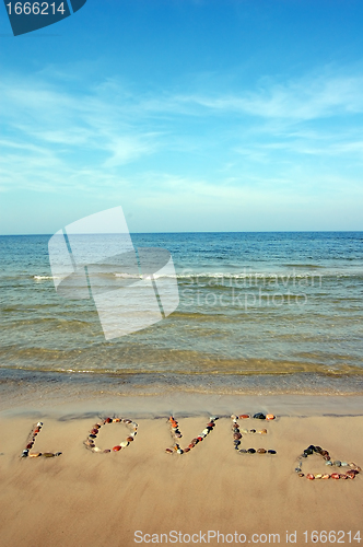 Image of Word LOVE on beach sand