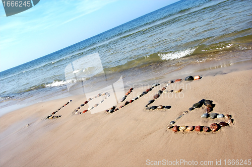 Image of Word LOVE on beach sand