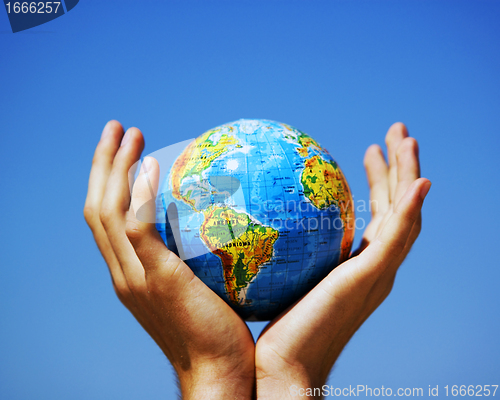 Image of Earth globe in hands. Conceptual image