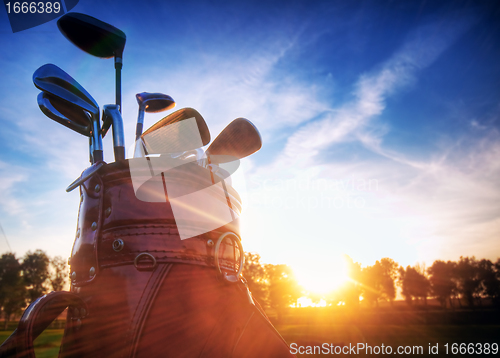 Image of Golf gear, clubs at sunset