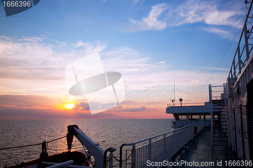 Image of Ship deck view, ocean at sunset