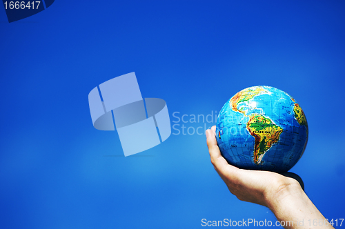 Image of Earth globe in hands. Conceptual image