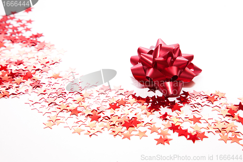 Image of Christmas decoration, red ribbon and stars
