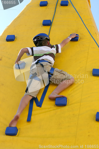 Image of Boy climbing a climbing wall.