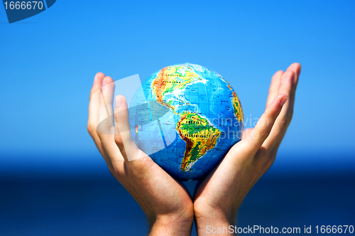 Image of Earth globe in hands. Conceptual image