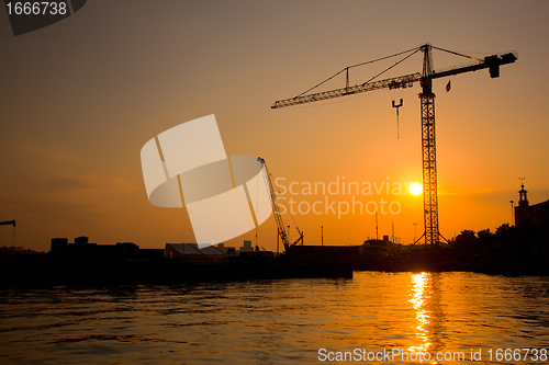 Image of Industrial harbor at sunset and a crane