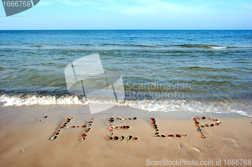 Image of Word HELP on beach sand