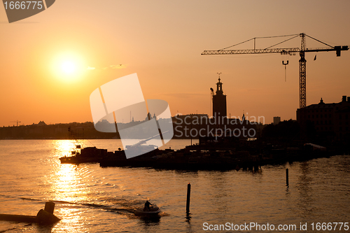 Image of Industrial harbor at sunset and a crane