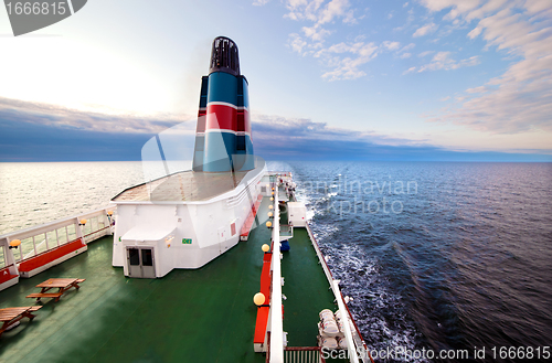 Image of Ship deck, board view, ocean at sunset