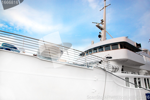 Image of White tourist ship close up on blue sky