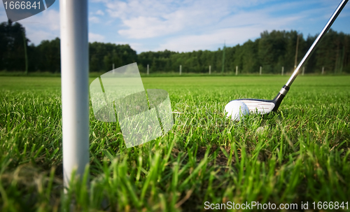 Image of Playing golf. Club and ball on tee