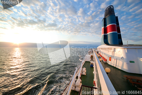 Image of Ship deck, board view, ocean at sunset