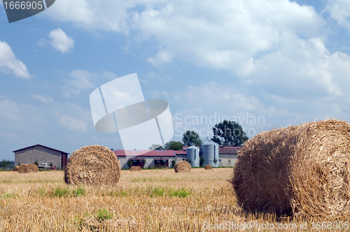 Image of Farm buildings and haystacks