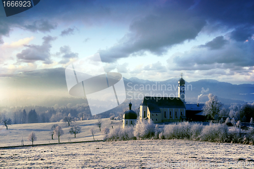 Image of Alpine scenery with church in the frosty morning