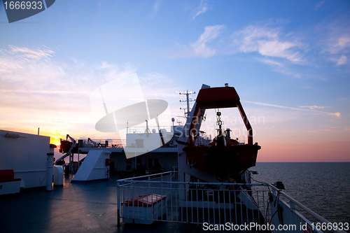 Image of Ship deck view, ocean at sunset