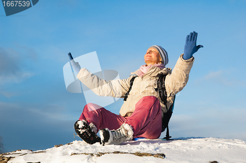 Image of woman sitting outdoors and enjoy the Sun