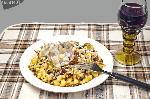 Image of  cut-up and sugared pancake with raisins