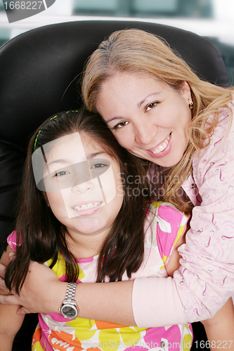 Image of Close up of affectionate mother and daughter at home