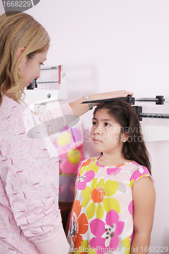 Image of Doctor measure little child girl height growth 