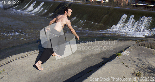 Image of Shirtless man walking.