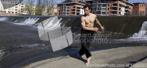 Image of Man dancing outdoors.