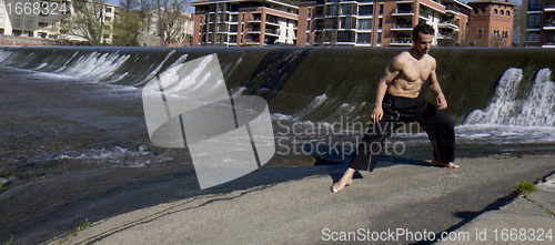 Image of Well shaped man exercising outdoors.