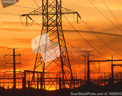 Image of Electricity pylons at orange sunset 