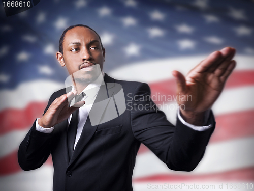 Image of young African American guy and a flag