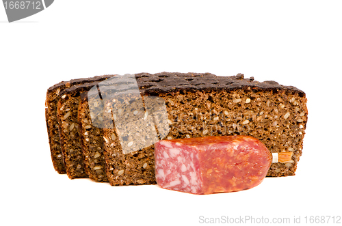 Image of cut smoked sausage and dark bread grain pieces 