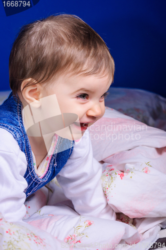 Image of Cheerful young child in bed