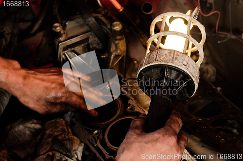 Image of Mechanic worker inspecting car interiors