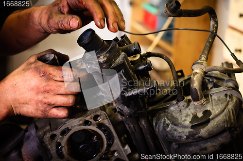 Image of Worker repairing mechanical component