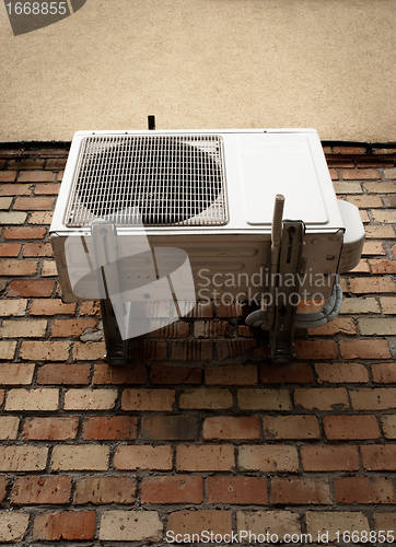 Image of Air conditioner on brick wall