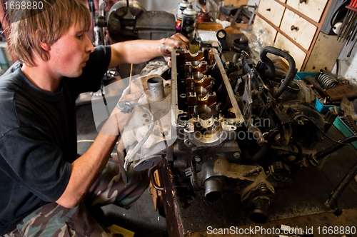 Image of Mechanic worker inspecting car interiors