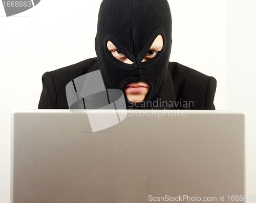 Image of Woman internet hacker using laptop to rule the world