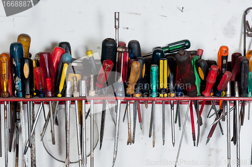 Image of Screwdrivers against white wall hanging