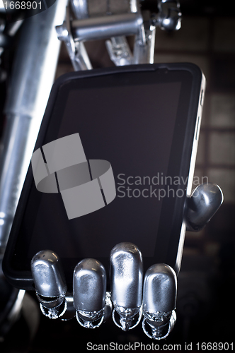 Image of Robot hand holding tablet pc