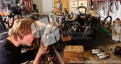 Image of Worker with car engine