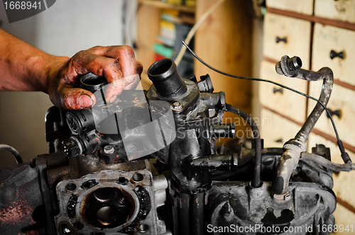 Image of Worker repairing broken motor