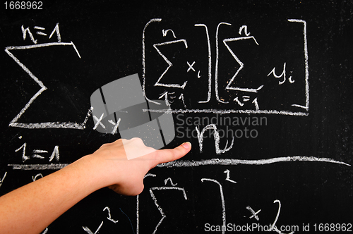 Image of Hand of a girl pointing at chalkboard