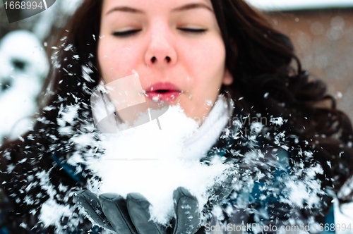 Image of Woman blewing snow in my face