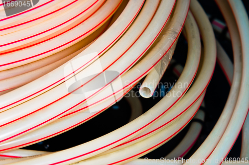 Image of White plastic pipes in a stack