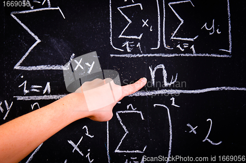 Image of Hand of a girl pointing on mathematical test