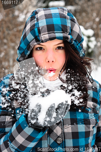 Image of Attractive young woman with snow in her hand