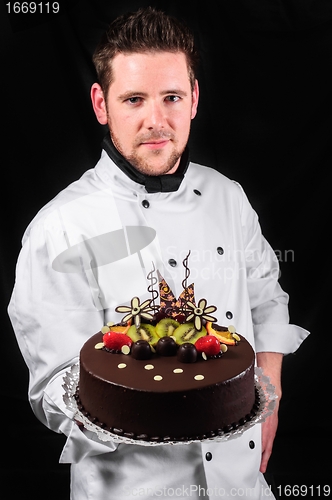 Image of Handsome chef with cake