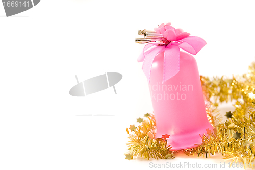 Image of golden tinsel with pink glass decoration