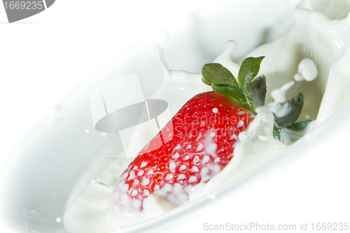 Image of strawberry splashing into milk