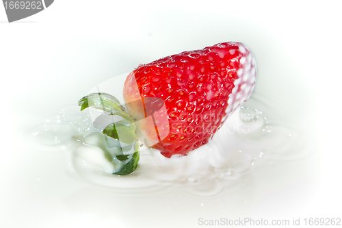 Image of strawberry splashing into milk