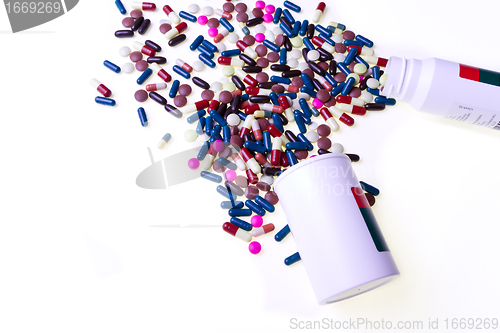 Image of pills spilling out of container 