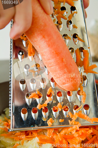 Image of chef grating carrot